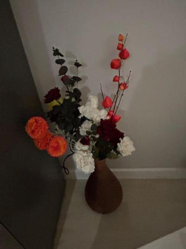 a brown vase filled with flowers in a room at Castle in Old Sarum