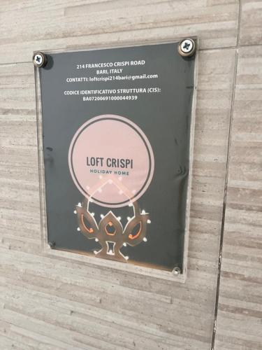 a sign on the wall of a building with a light crisis sign at Loft Crispi in Bari