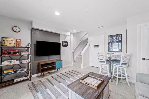 a living room with a television and a table at The Wright Stuff OBX in Kill Devil Hills
