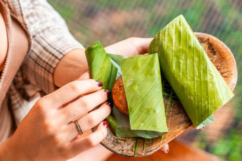 a woman holding a plate of food in her hands at La Loma Jungle Lodge and Chocolate Farm in Bocas del Toro