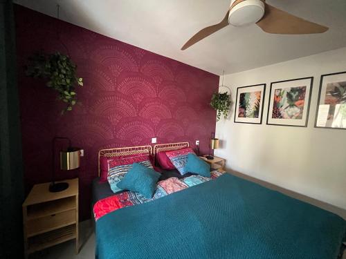 a bedroom with a blue bed with a purple wall at La Chata in Costa Calma
