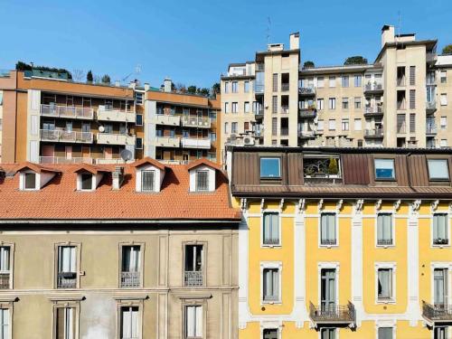 a group of tall buildings in a city at Artistic 2-bedroom condo in Milan