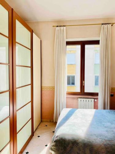 a bedroom with a bed and a window at Artistic 2-bedroom condo in Milan