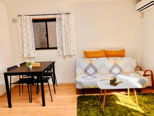 a living room with a couch and a table at 4BR Spacious Home, 10min to Umeda, 8 Guests in Osaka