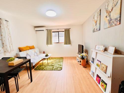 a living room with a white couch and a table at 4BR Spacious Home, 10min to Umeda, 8 Guests in Osaka