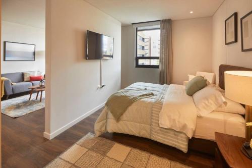 a bedroom with a bed and a living room at Cozy & Convenient in Calucé Chía Ideal Getaway in Chía
