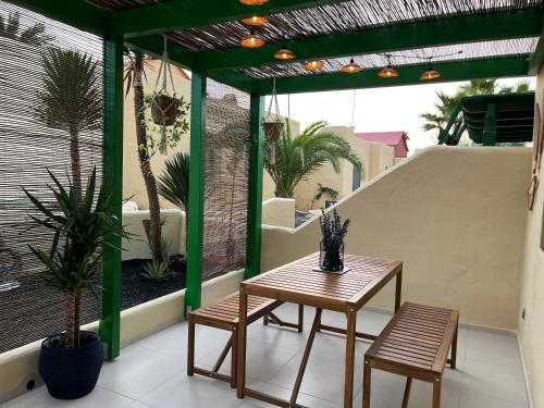 a patio with a table and chairs on a balcony at La Chata in Costa Calma
