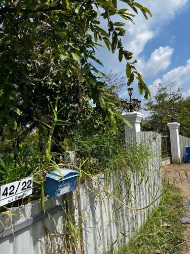 a fence with plants on top of it at Cozy breezing countryside Pet in Ban Khlong Sip Sam Lang