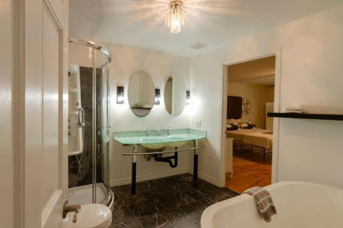 a bathroom with a sink and a mirror and a tub at Vineyard & Craft House - Rare 6 bedroom Gem in Picton in Picton