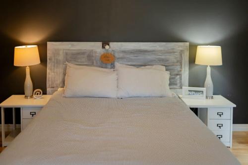 a bedroom with a large bed with two lamps at Central PEC gem - Craft Suite Sleeps up to 6 in Picton