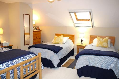 a bedroom with two beds and a skylight at The White Mountain Escape in Woodstock