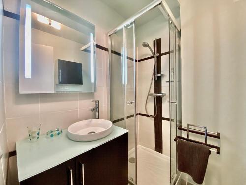 une salle de bain avec un lavabo et une douche en verre dans l'établissement Lou Paradou Classé 3 etoiles plage à 3mn à pieds parking ByLaConciergerie13, à La Ciotat