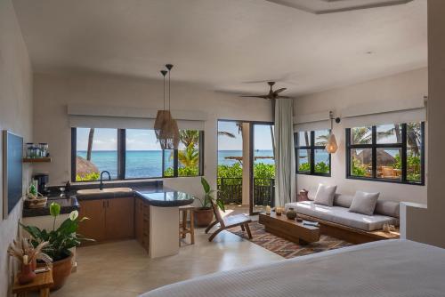 a living room with a view of the ocean at Mantaray Tulum in Tulum