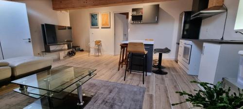 a living room with a couch and a table at Montelly in Crassier