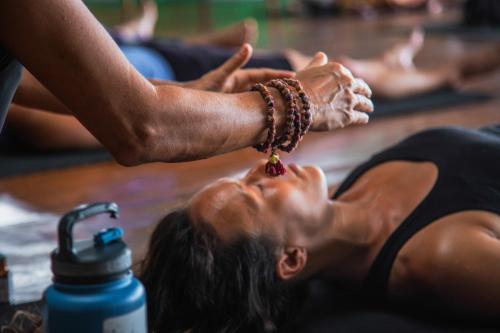 a group of people doing yoga on the floor at La Loma Jungle Lodge and Chocolate Farm in Bocas del Toro