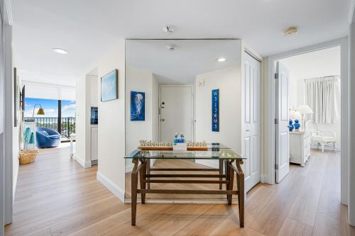 a living room with a glass table in the middle at Our House at the Beach 501W By Beachside Management in Siesta Key