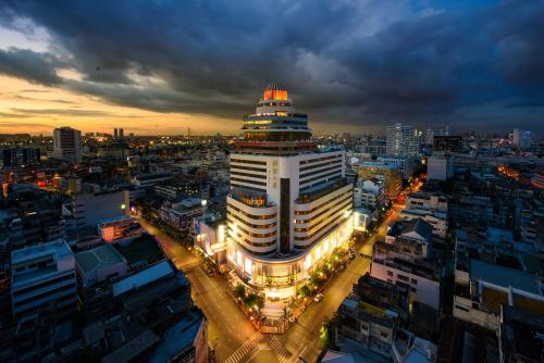a lit up building in a city at night at Grand China Bangkok in Bangkok