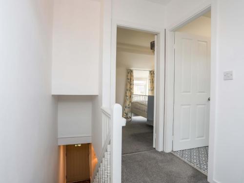 a hallway with a door leading to a bedroom at Cwrt in Dwyran