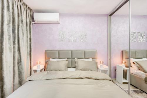 a bedroom with a large bed with purple walls at Elegant Old Town Escape in Bucharest