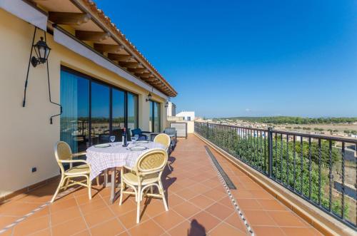 a patio with a table and chairs on a balcony at Can Nadal - Adults Only in Sineu