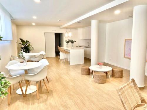 a living room with two tables and chairs and a kitchen at Denia Apartment Rental - Vivir La Vida in Denia