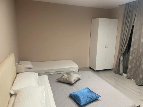 a small room with two beds and a cabinet at Meri Hause in Vlorë