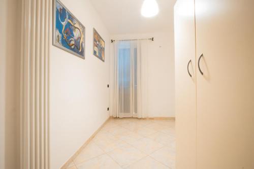 a hallway with white walls and a tile floor at Adua Apartment in Polignano a Mare