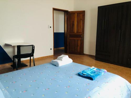 a bedroom with a bed and a chair and a desk at Villa SAIDIA climatisée avec PISCINE in Diego Suarez