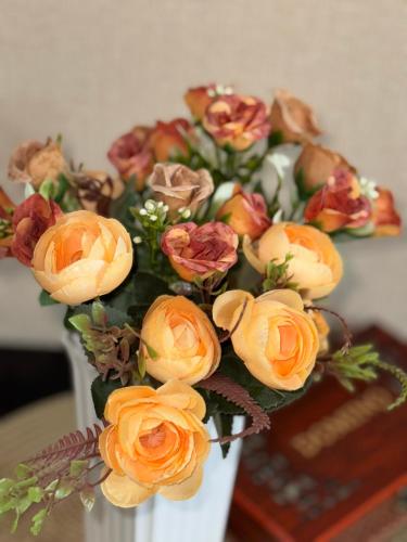 a bouquet of flowers in a white vase at Tamuna Apartment In New Gudauri - Block 3 - N315 in Gudauri