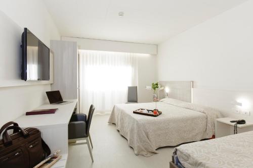 Postel nebo postele na pokoji v ubytování Alfa Fiera Hotel