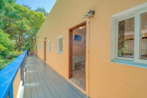 a balcony of a house with a door and a table at Caribe Tesoro in West Bay