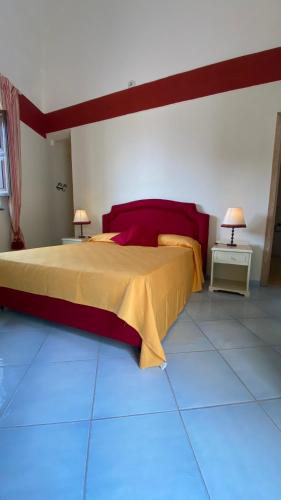 a bedroom with a bed with red and yellow sheets at Casa Santicelli - Room in Maratea
