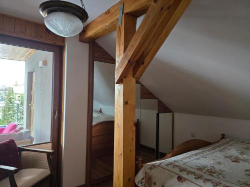 a bedroom with a bed with a wooden frame at Barytowy apartament in Tarnowskie Góry