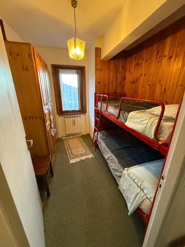 a room with two bunk beds and a window at Home Beta in Terminillo