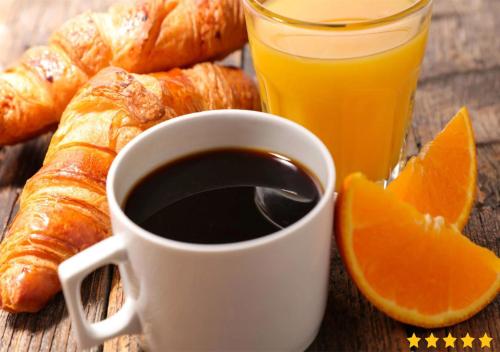 a cup of coffee and croissants and a glass of orange juice at Résidence Pasino in Lacanau-Océan