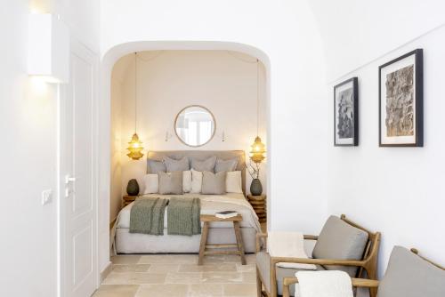 a bedroom with a bed and a table and chairs at casa Olympia in Polignano a Mare