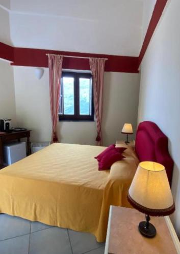 a bedroom with a large bed with a yellow blanket at Casa Santicelli - Room in Maratea