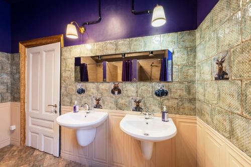 a bathroom with two sinks and a mirror at Guesthouse32 in Sofia