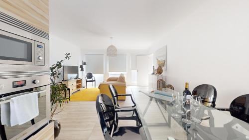 a kitchen and living room with a table and chairs at Azores Calheta Inn Apartment B 1ºDrto in Ponta Delgada