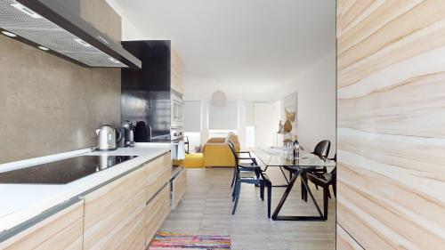 a kitchen with a counter and a table with chairs at Azores Calheta Inn Apartment B 1ºDrto in Ponta Delgada