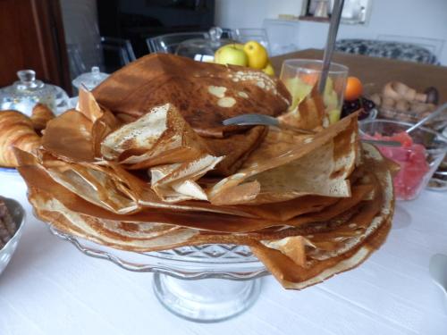 a bowl of chips and bread on a table at Les Chambres d'hôtes de Kérasquer in Lannilis