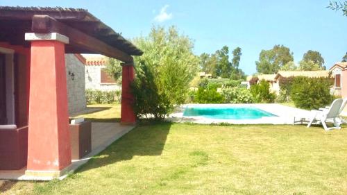 a house with a swimming pool in a yard at Villas with private pool in Costa Rei just 500 meters from the sea in Costa Rei
