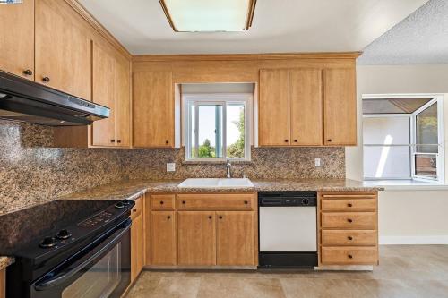 a kitchen with wooden cabinets and a sink at RoomL in Hayward