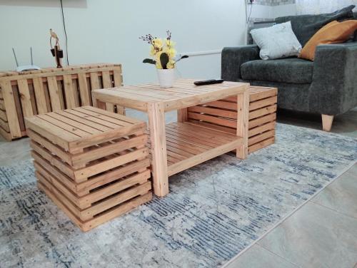 a wooden coffee table in a living room at Royal Stay in Kira