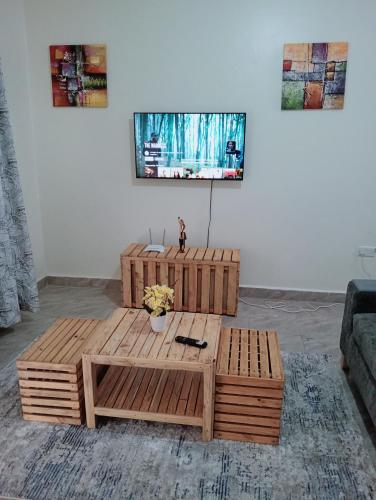 a wooden coffee table in a living room at Royal Stay in Kira