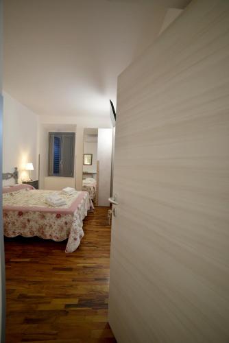 a room with two beds and a door to a bedroom at Il Palazzetto in Bolsena