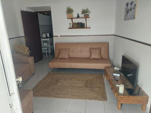 a living room with a couch and a table at Casa da Pedra in Cabeça de Carneiro