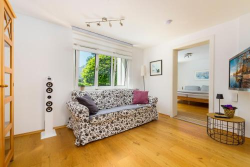 a living room with a couch and a window at Bregenzer Traum am Bodensee inkl Fahrräder in Bregenz