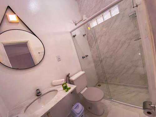 a bathroom with a shower and a toilet and a sink at MOVA - Hotel Costa Azul in Ubatuba