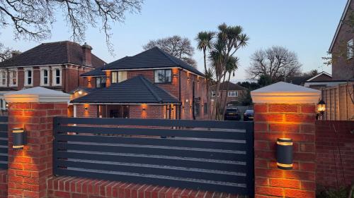 a fence in front of a house with houses at Lux 7 Bedroom residence in Waterlooville